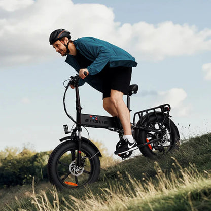 Electric Bike Engwe Engine X features a sporty design, riding down a grassy slope with oversized tires.