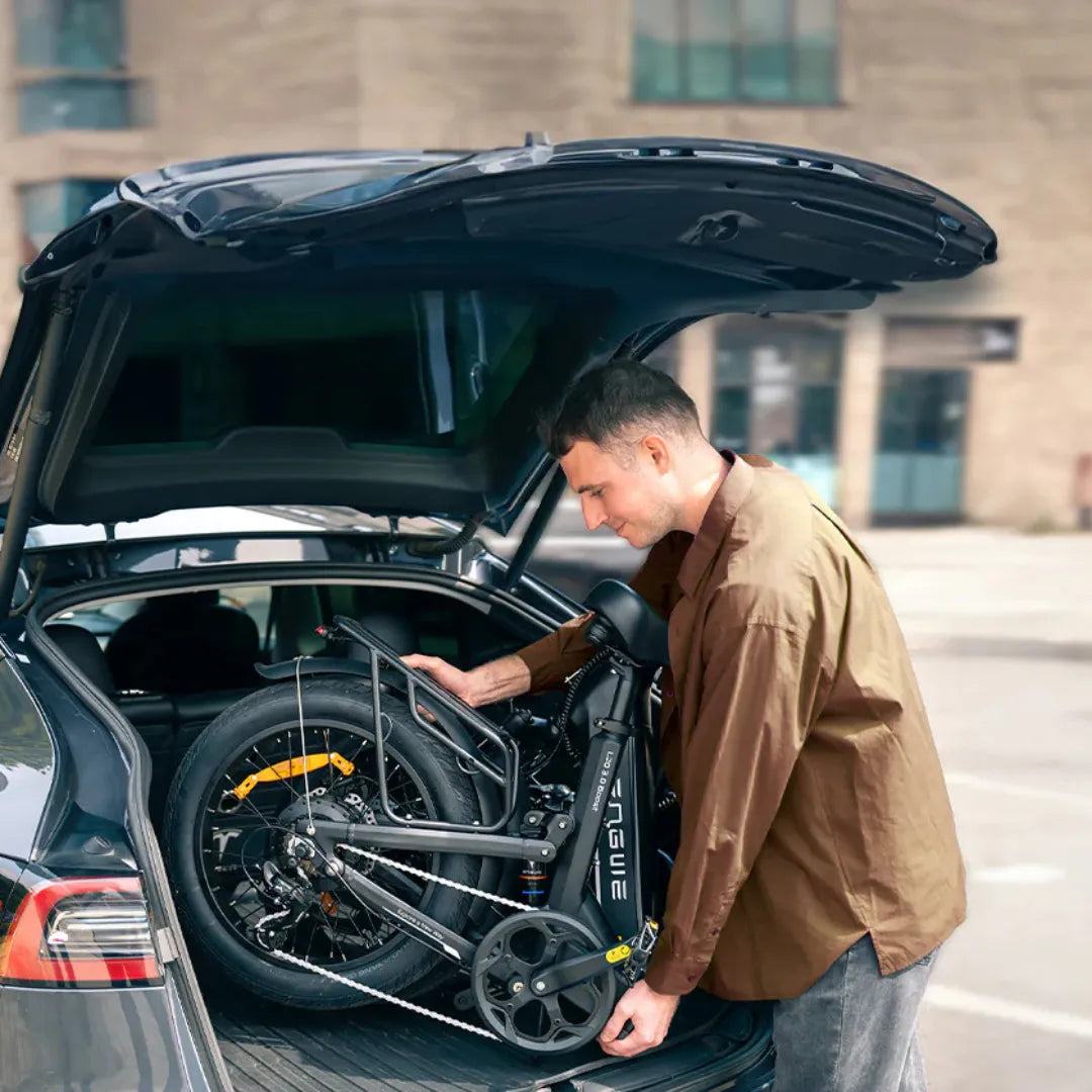 Electric Bike Engwe L20 3 0 Boost is compactly folded and being loaded into a car trunk.