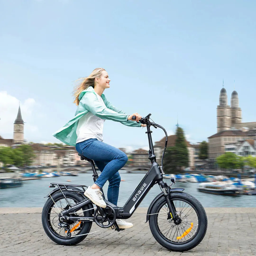 Electric bicycle Engwe L20 3.0 Boost – woman riding by a waterfront city