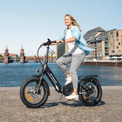 Electric Bike Engwe L20 3 0 Pro features a sleek design, wide tires, and a stylish rider by the water.