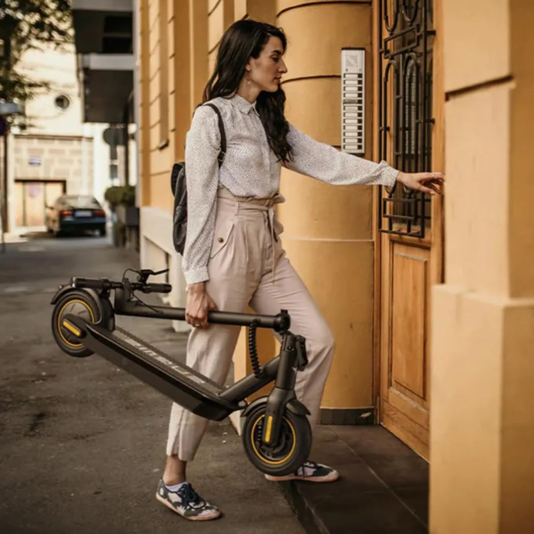 Electric scooter Engwe Y10 – woman carrying folded scooter up steps