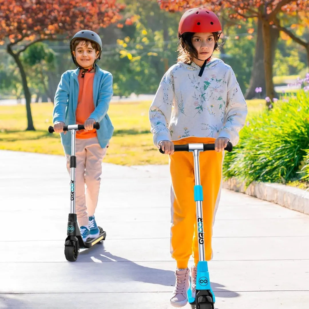 Two children ride Gyroor H30 electric scooter in a solar park, wearing helmets and normal clothes