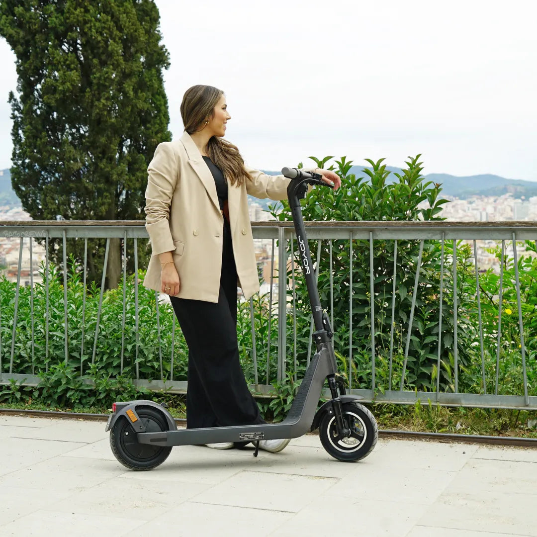 Electric scooter Joyor LiteGo – woman standing with scooter outdoors