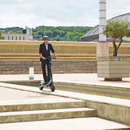 Electric Scooter Joyor Luxerider features a sleek design, perfect for urban commuting, with a rider in a suit.