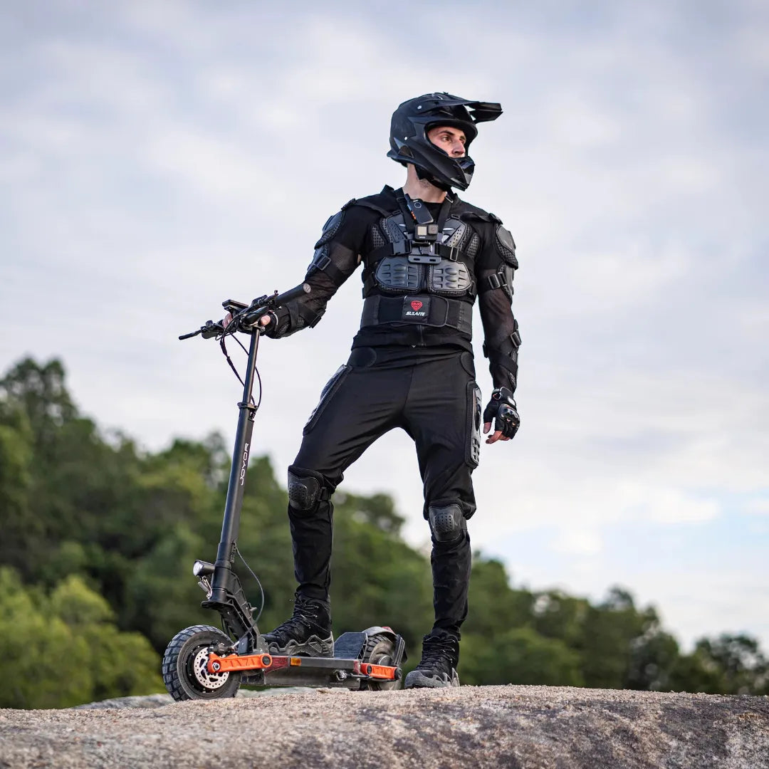 Electric scooter Joyor S5-Z – rider standing with scooter on rock