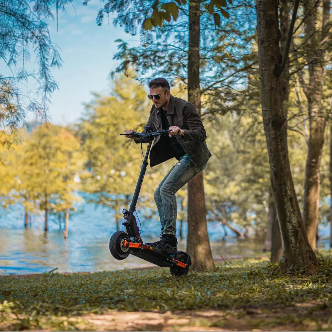 Electric scooter Joyor S10-S-Z – man riding, front wheel lifted, outdoor