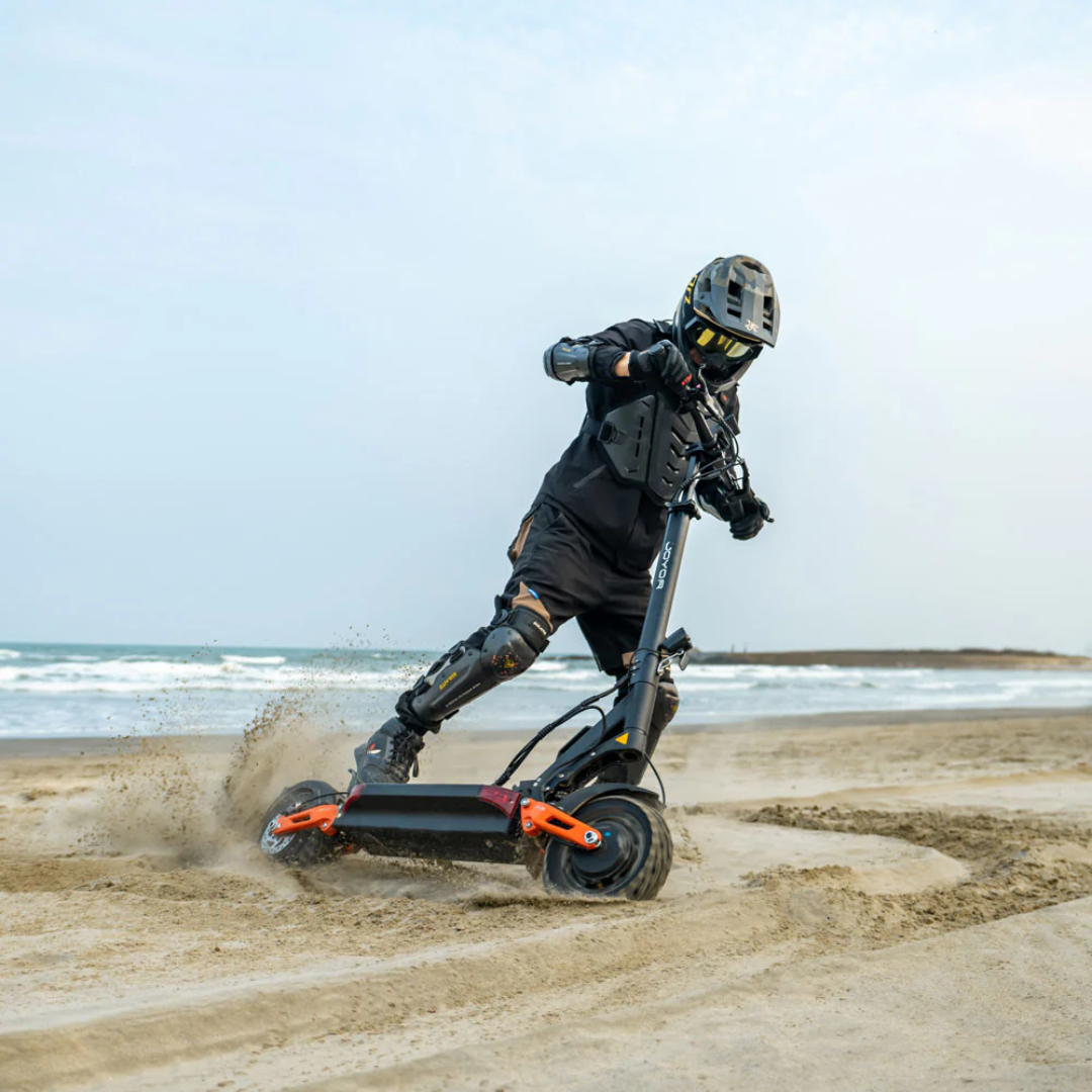 Electric scooter Joyor T10 – person riding on sand at beach