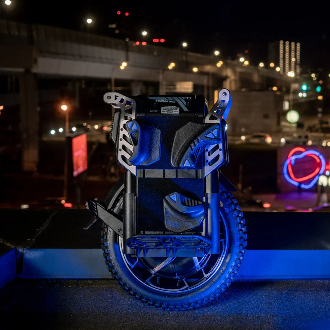Electric Unicycle Kingsong F22 Pro features a sleek design with sturdy footrests and a robust tire, illuminated at night.