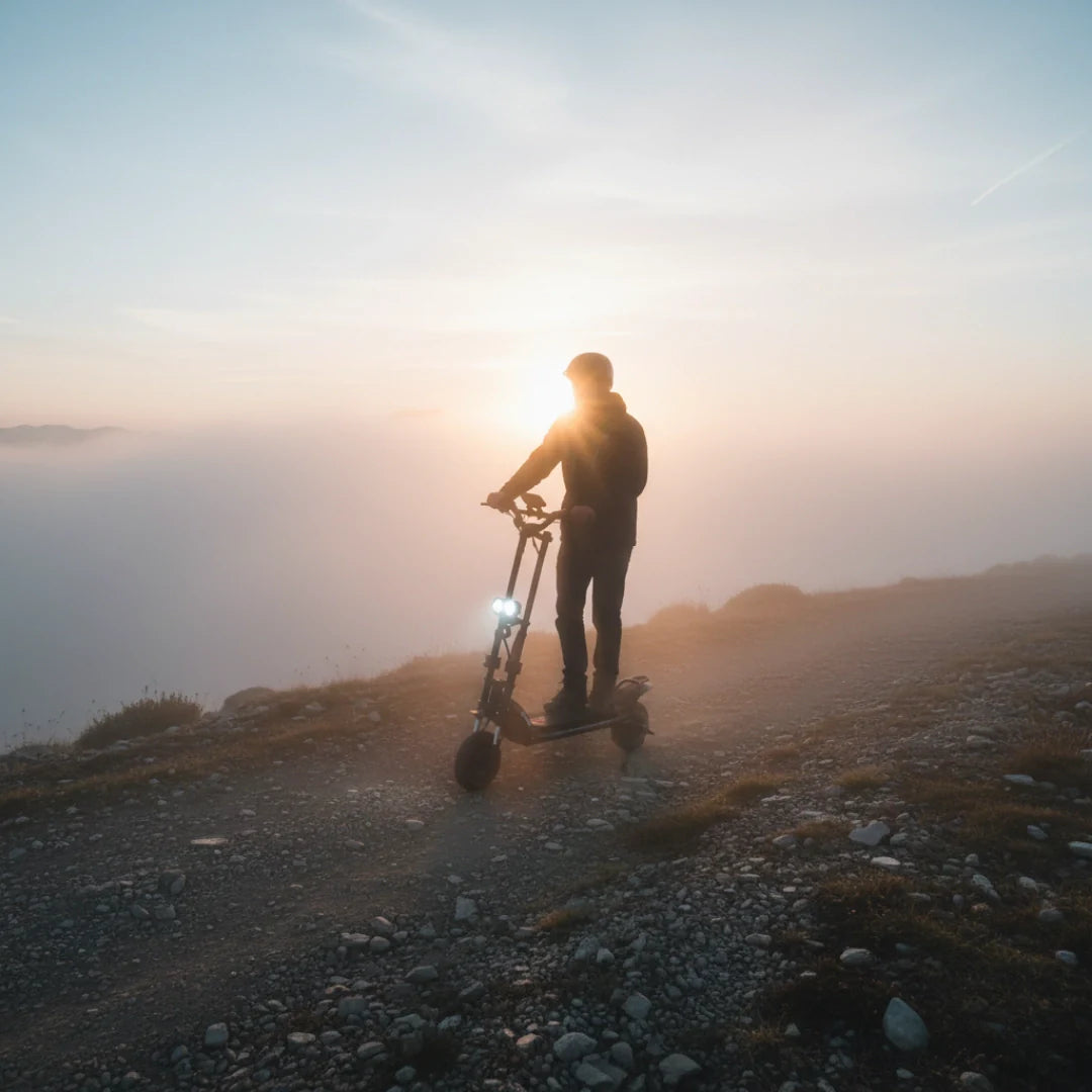 Electric scooter Kaabo Wolf Warrior X MAX – person riding at sunset on mountain