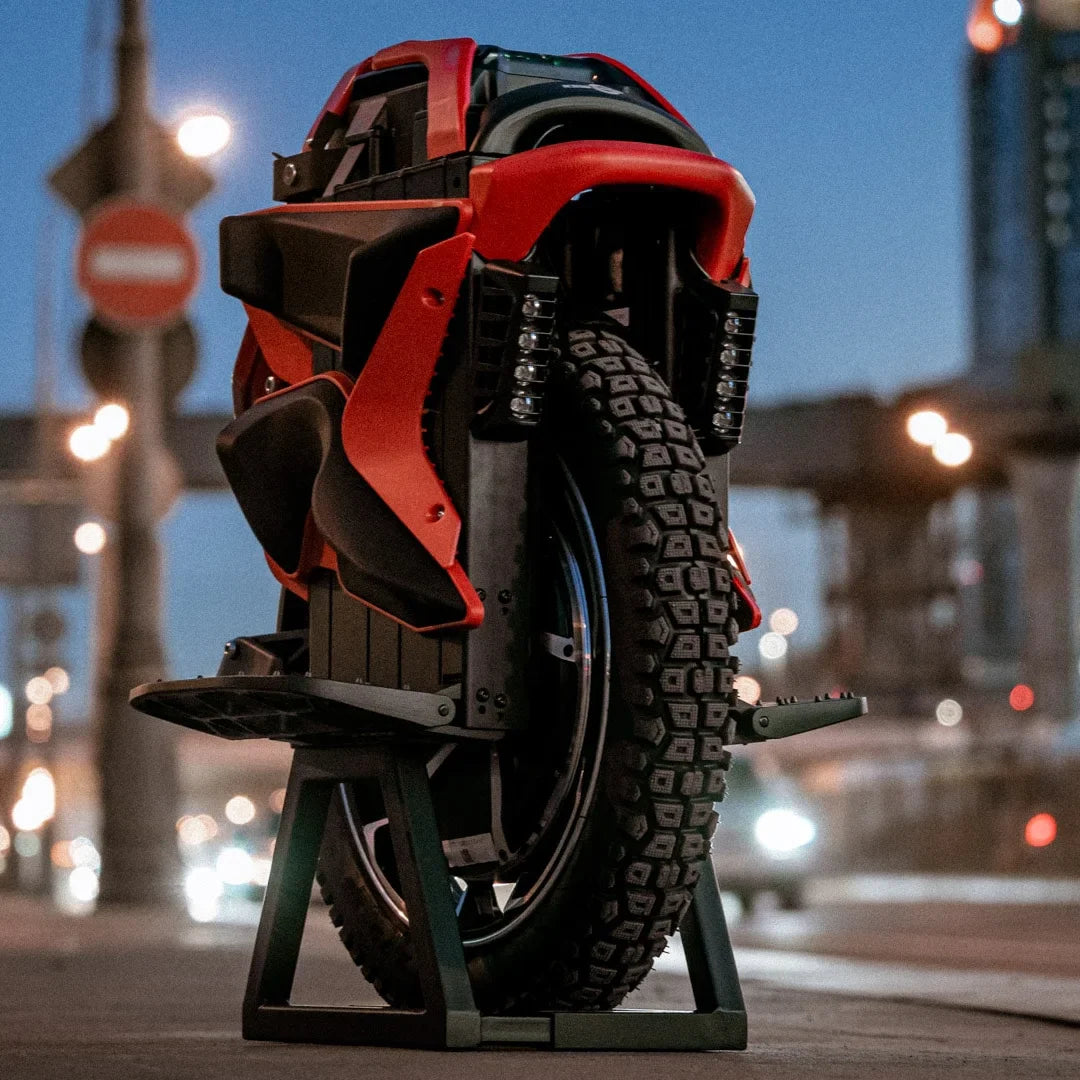 Electric unicycle KingSong S22 Pro+ – red body on stand, urban background
