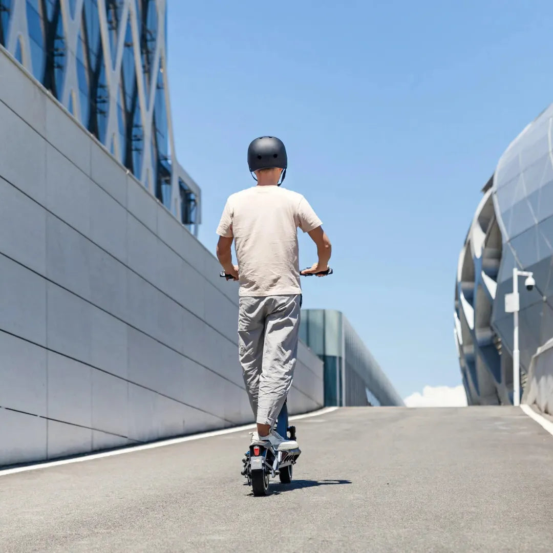 Electric scooter KingSong N12 Pro – rear view, rider on urban road