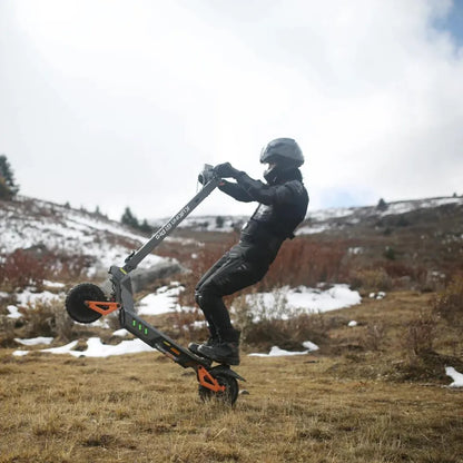 Electric Scooter Kukirin G1 Pro, showcasing a rider performing a stunt on a rugged terrain with snow.