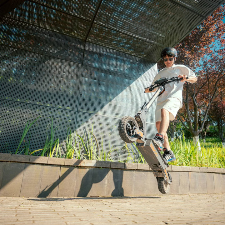 Electric scooter KuKirin G2 – man performing a wheelie stunt