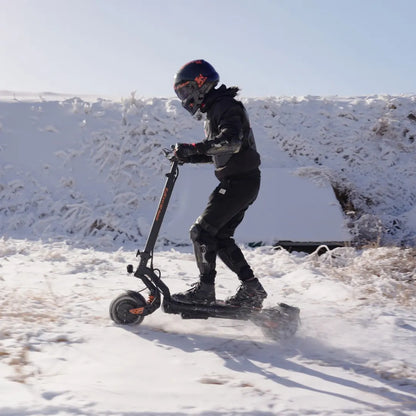 Electric Scooter Kukirin G2 Master, designed for winter riding, showcases a rider in protective gear navigating through snow.