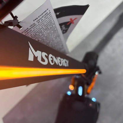 Electric Scooter Ms Energy Flare X Pro features a sleek design, illuminated branding, and safety warning tags.