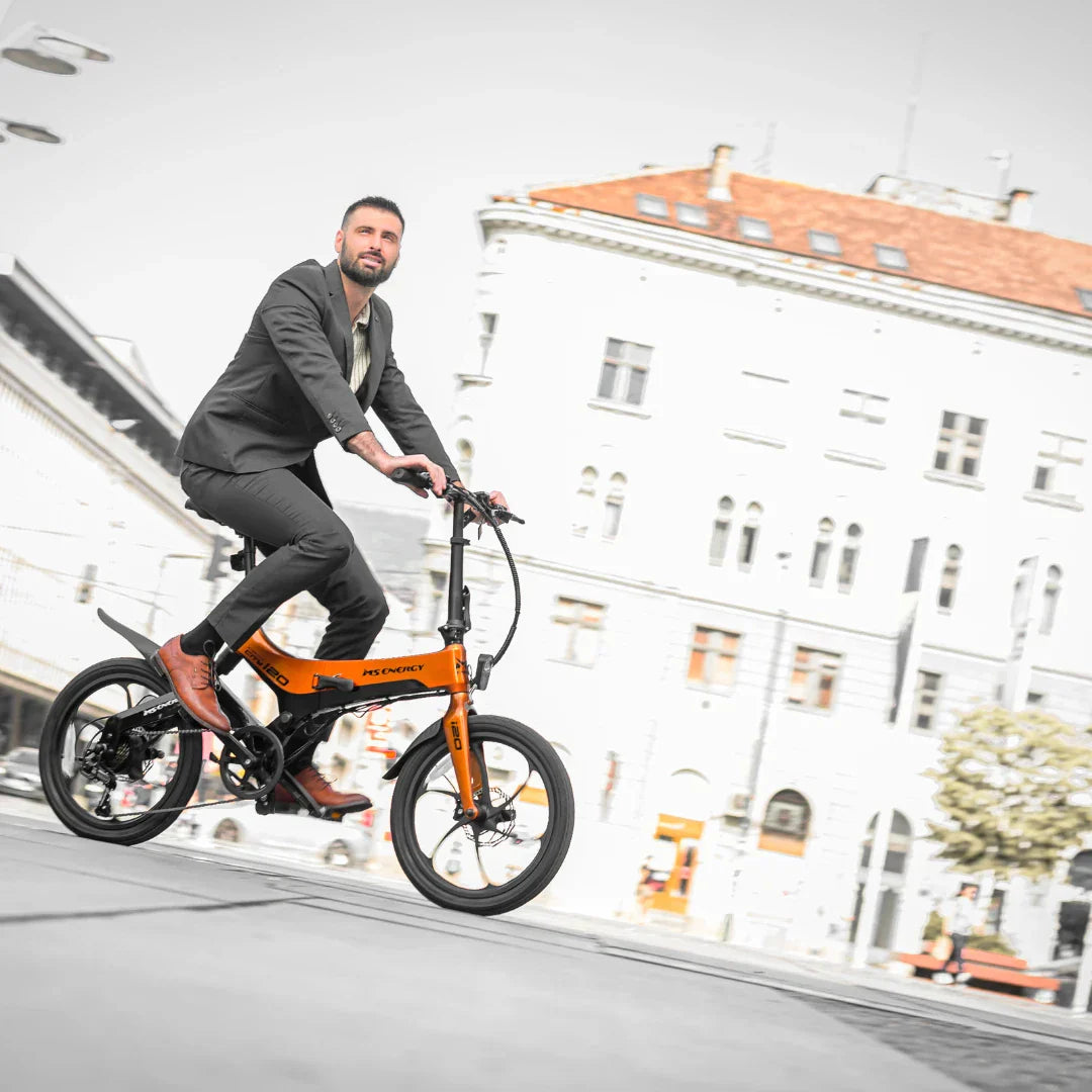 Electric bicycle MS Energy StreetFlex i20 – man riding, front three-quarter view, city street