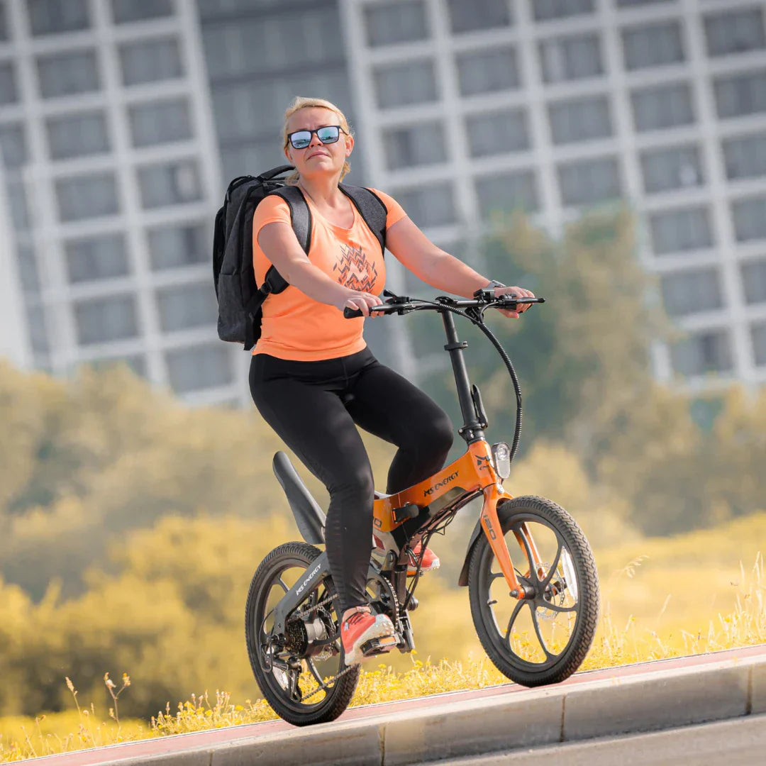 Electric bicycle MS Energy StreetFlex i20 – woman riding, front three-quarter view, uphill