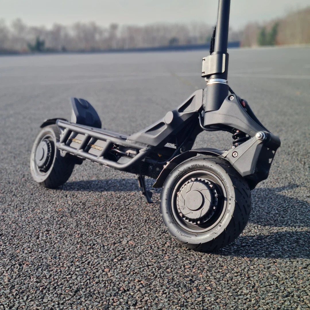 An electric scooter Nami Blast 2 Max is showcased on a paved surface, highlighting its sturdy design and large wheels