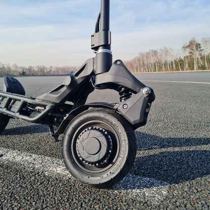 Close-up of the wheel and suspension of the electric scooter Nami Blast 2 Max on an asphalt surface