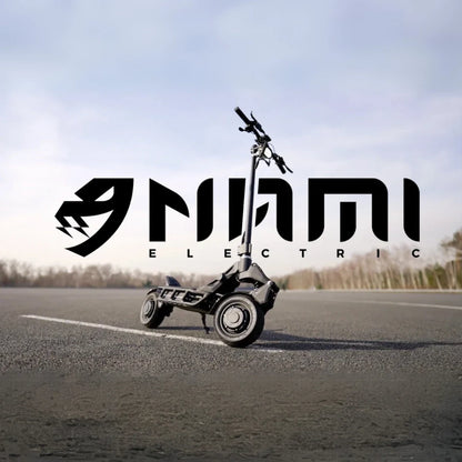An electric scooter Nami Blast 2 Max is parked on an empty road with a logo in the background