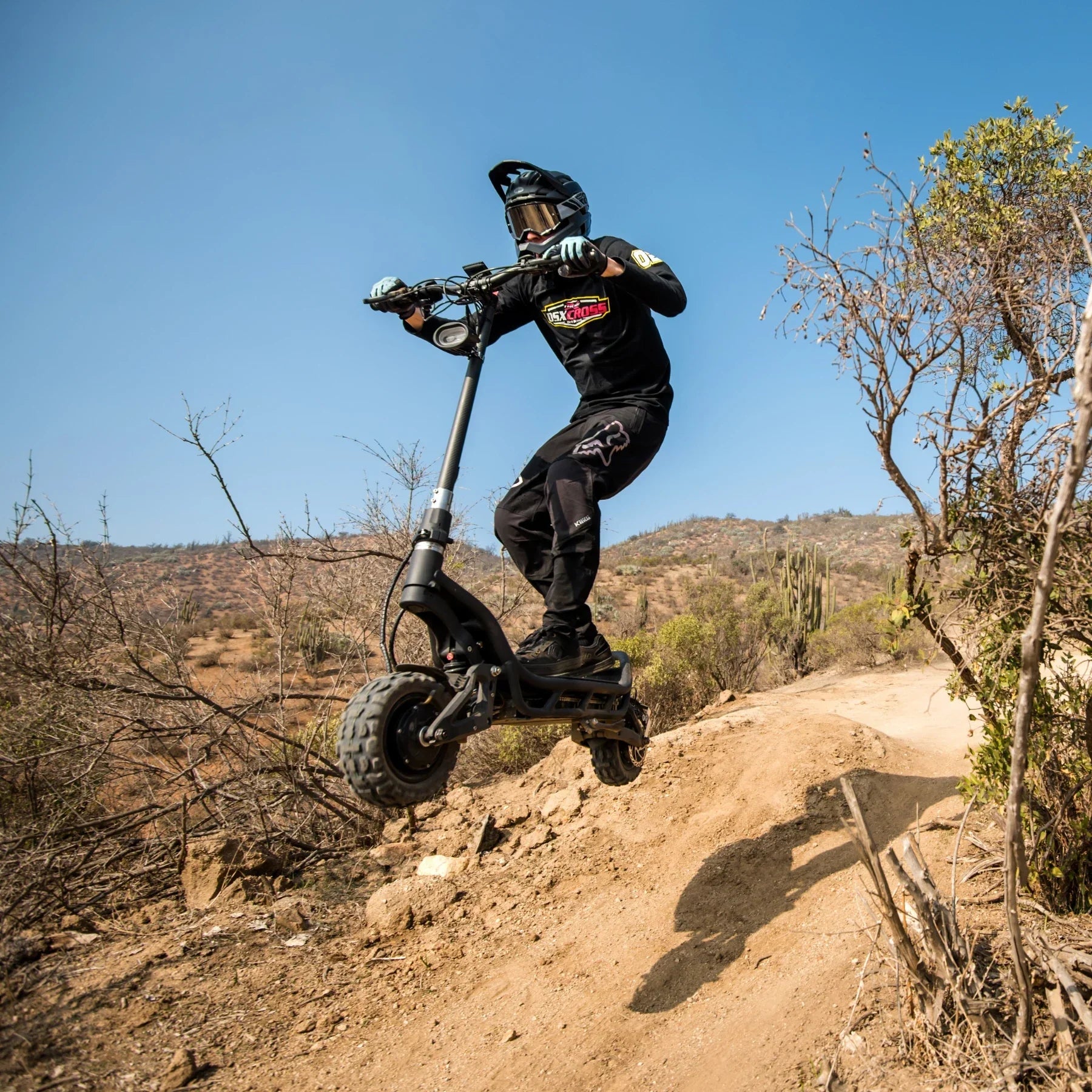 Electric Scooter Nami Burn E 3 Max, an all-terrain scooter soaring over a rugged landscape.