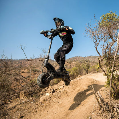 Electric Scooter Nami Burn E 3 Max, an all-terrain scooter soaring over a rugged landscape.