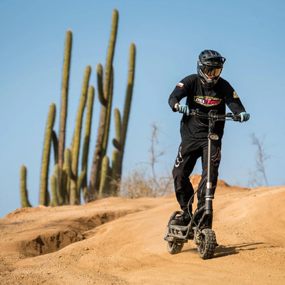 Electric Scooter Nami Burn E 3 Max features rugged design, off-road tires, and a rider on a dirt path.