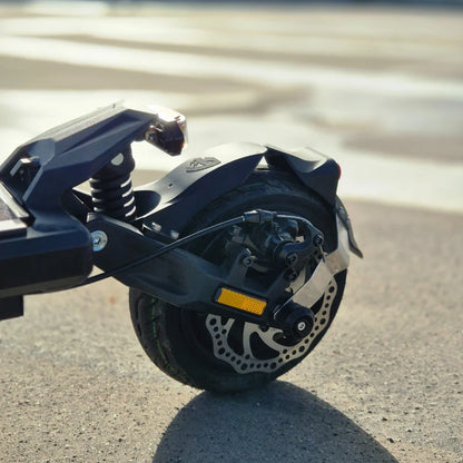 Electric Scooter Nami Stellar features a robust rear wheel with a detailed disc brake, spring suspension, and sleek design.
