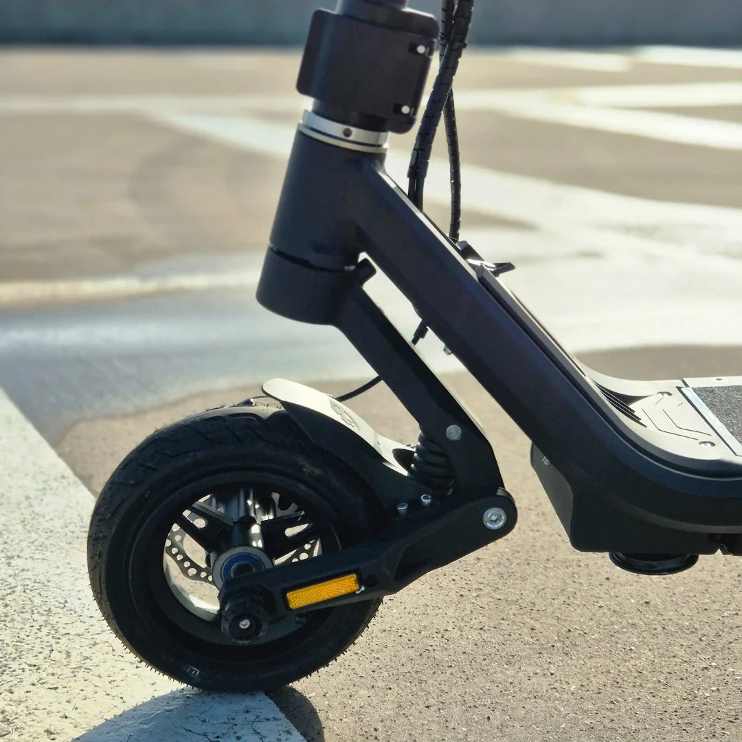 Electric Scooter Nami Stellar features a robust build, showcasing a sleek front wheel and suspension design.