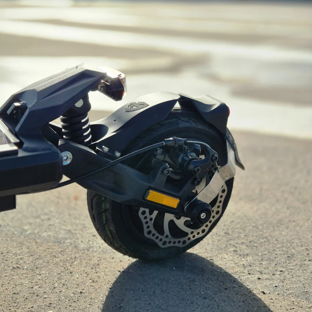 Electric Scooter Nami Superstellar, showcasing a robust rear wheel with dual braking system and suspension.