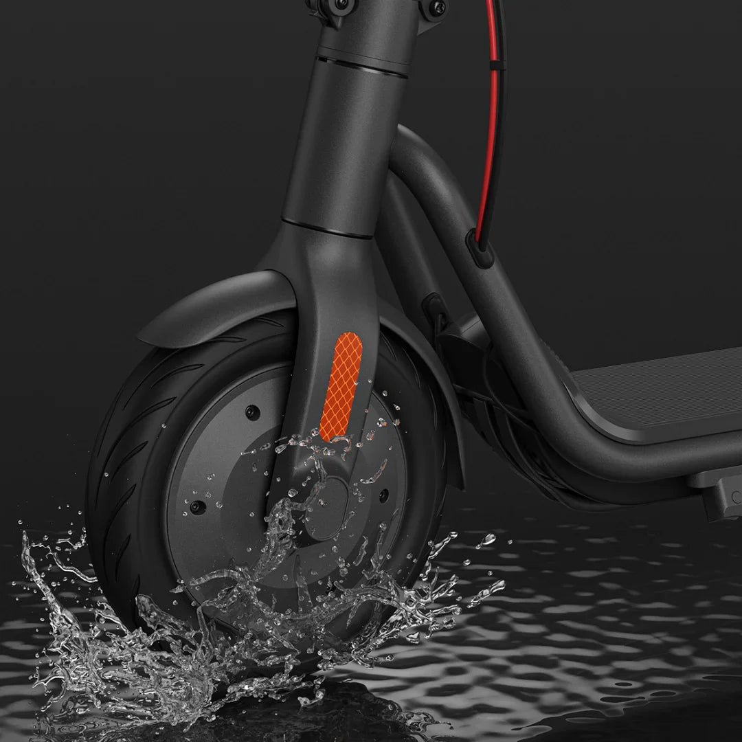 Electric Scooter Navee V50i Pro features a robust front wheel splashing through water, showcasing durability.
