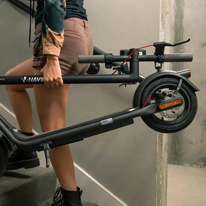 Electric Scooter Navee V50i Pro, sleek design, being carried up stairs, practical for urban commuting.