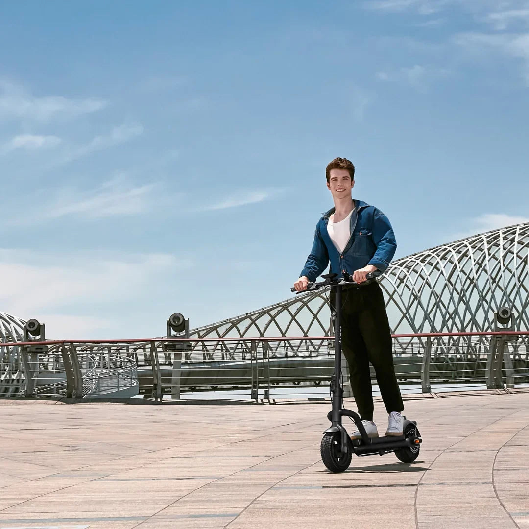 Electric Scooter Navee N65i, stylish and modern design, a rider confidently enjoying smooth rides outdoors.