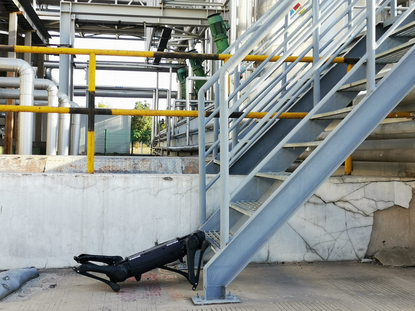 Unitree AlienGo – robot lying on ground near stairs