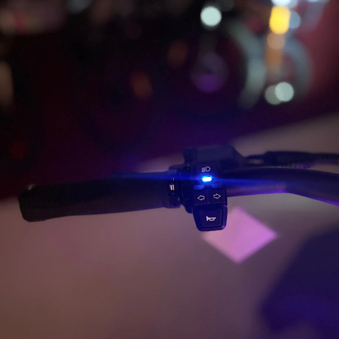 Electric Scooter Teverun Fighter Mini Pro 2025 features a close-up of the handlebar controls with illuminated buttons.