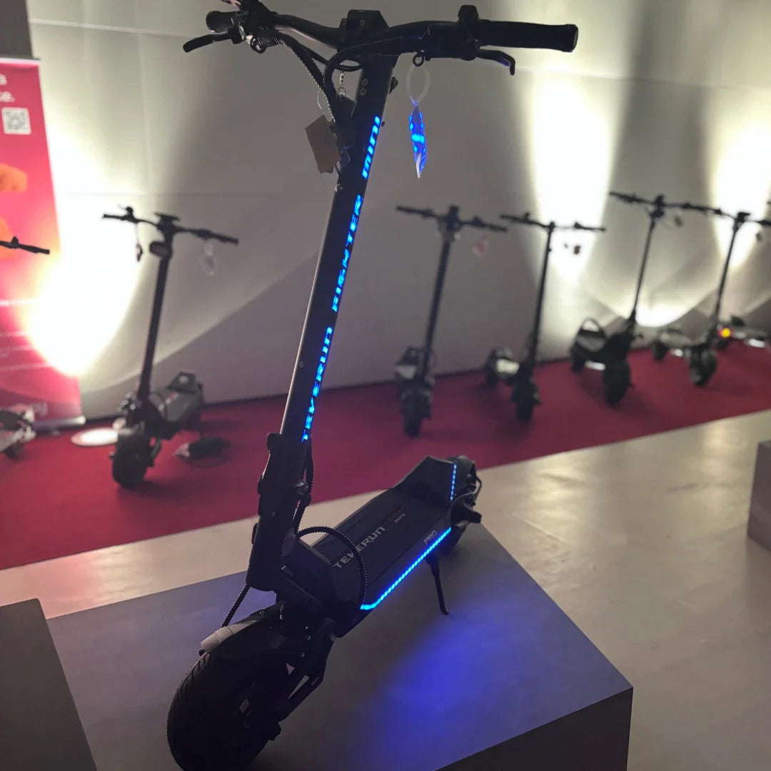 Electric Scooter Teverun Fighter Mini Pro 2025 features a sleek design with blue LED lights and robust wheels.