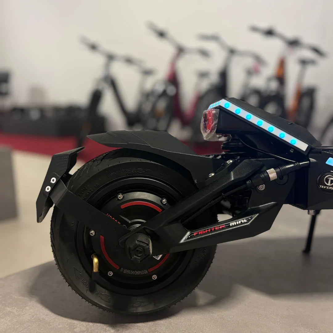 Electric Scooter Teverun Fighter Mini Pro 2025 features a sleek design, robust rear wheel, and colorful LED accents.