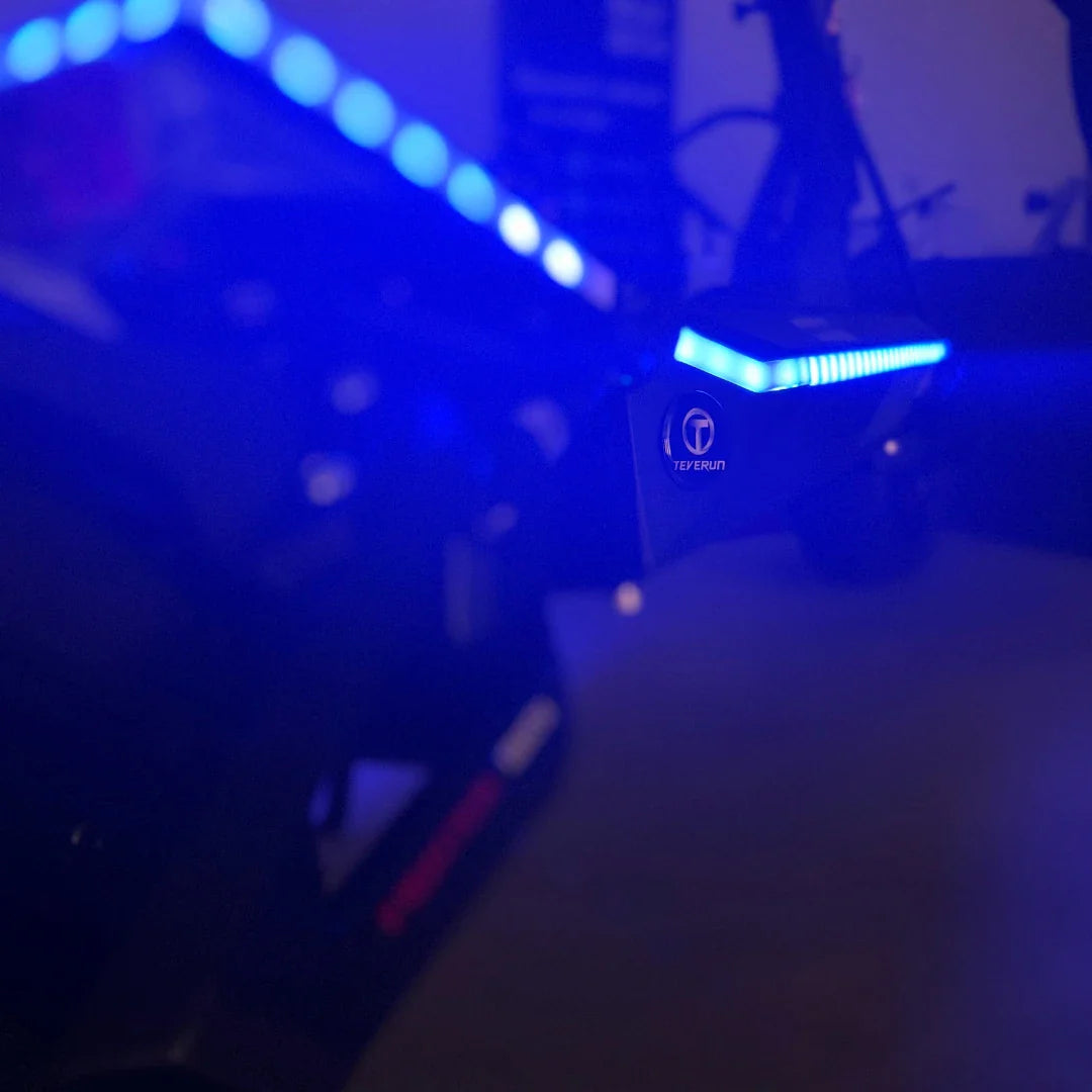 Electric Scooter Teverun Fighter Mini Pro 2025 features vibrant blue LED lights and sleek design.