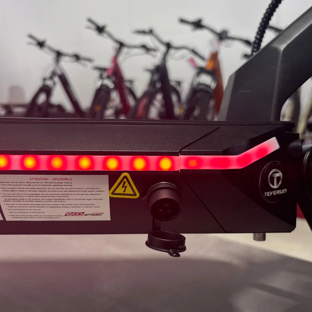 Electric Scooter Teverun Fighter Mini Pro 2025 features a sleek design with warning lights and charging port.