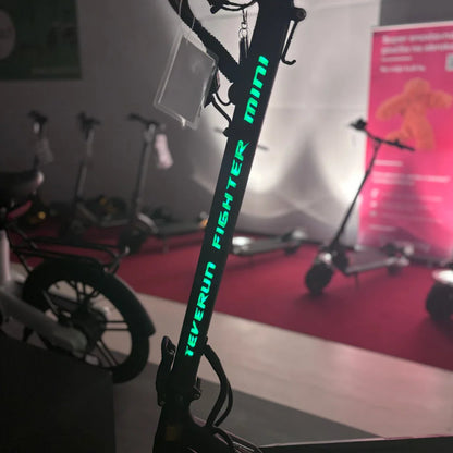 Electric Scooter Teverun Fighter Mini Pro 2025 features a sleek design with illuminated branding, perfect for urban travel.