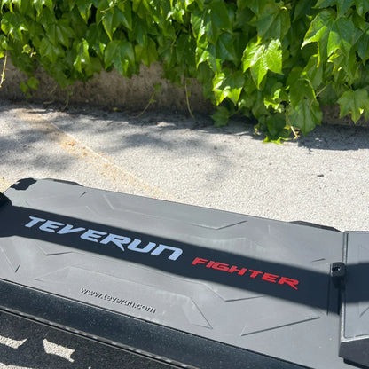 Electric Scooter Teverun Fighter 11 Plus features a sleek design with a sturdy deck, showcasing its branding.