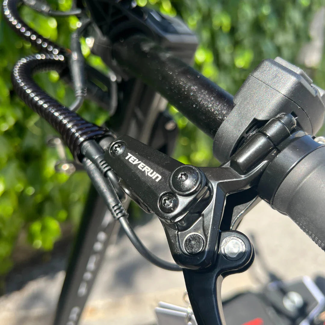 Electric Scooter Teverun Fighter 11 Plus features a close-up view of its sturdy handlebar brake system, sleek design.
