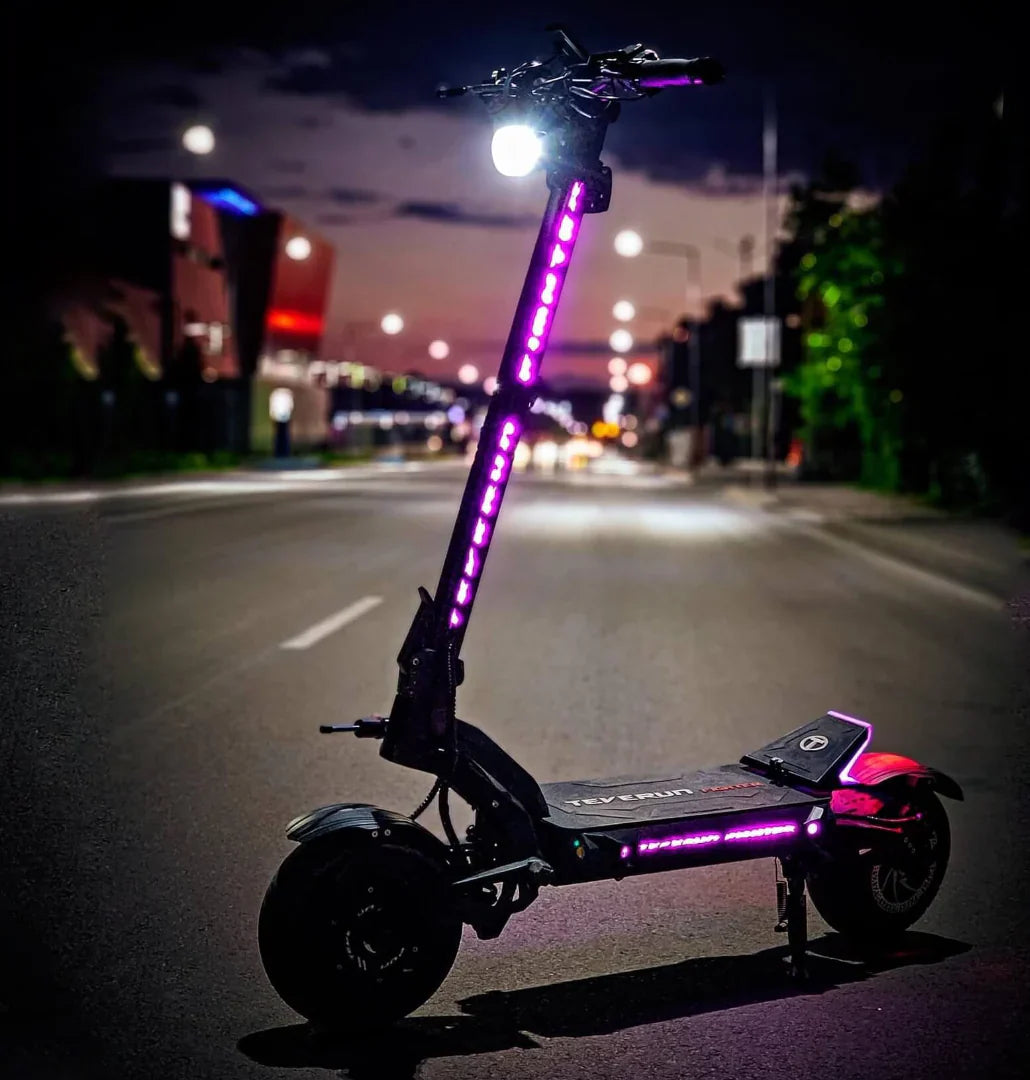 Electric scooter Teverun Fighter 11+ 2024 – side view with purple LED lights at night