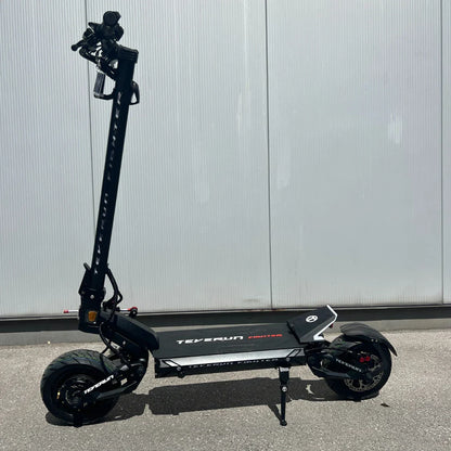 Electric Scooter Teverun Fighter Mini Pro 2025 features a sleek black design, a robust frame, and durable wheels.