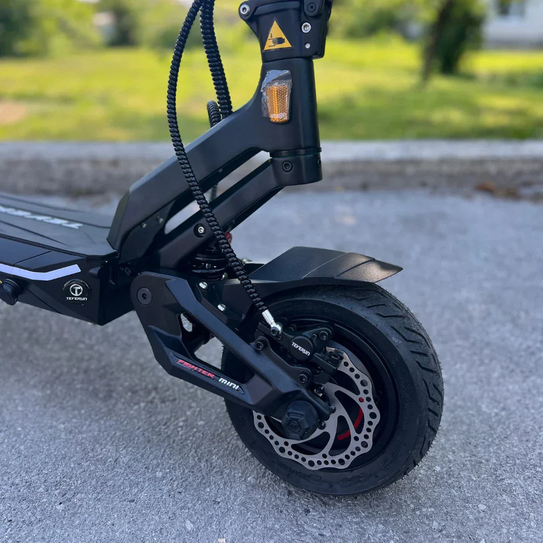 Electric scooter Teverun Fighter Mini PRO 2025 – front wheel, disc brake, and suspension close-up