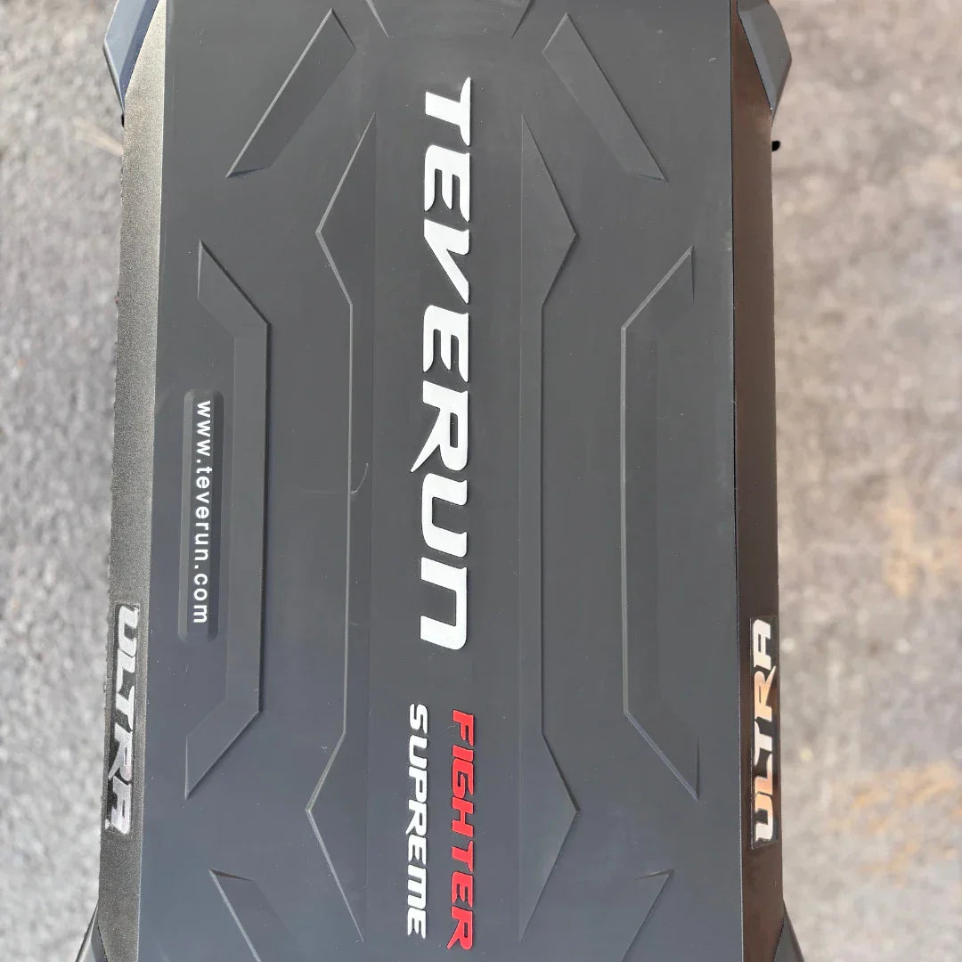 Electric Scooter Teverun Fighter Supreme 7260 Ultra features a sleek black design, with embossed logos and textures.