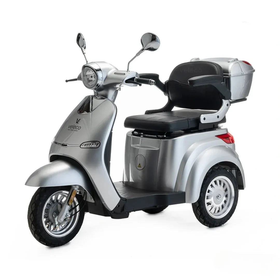 Electric Mobility Scooter Veleco Cristal features a sleek silver design, comfortable seating, and spacious storage.