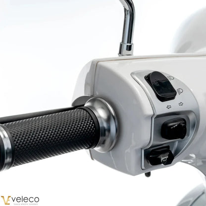 Electric Mobility Scooter Veleco Cristal features a sleek control panel with ergonomic grips, buttons for speed and direction.
