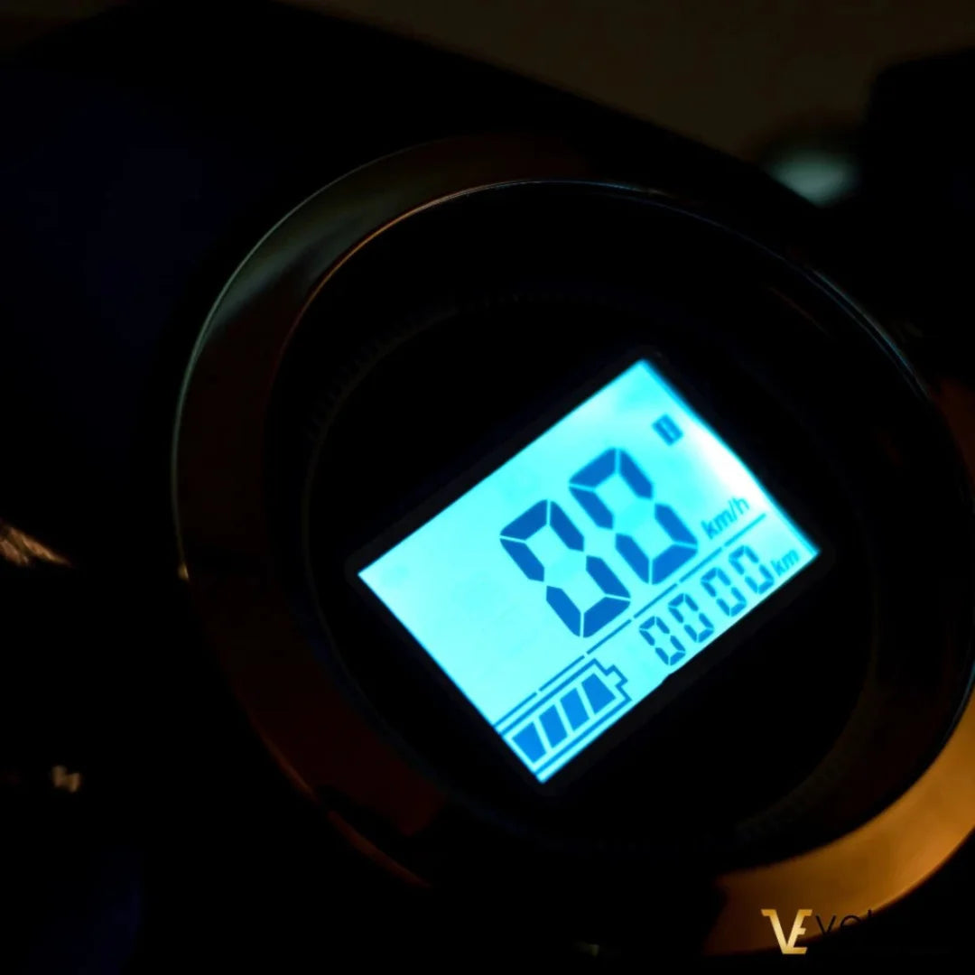 Electric Mobility Scooter Veleco Faster features a digital display showing speed and battery level.