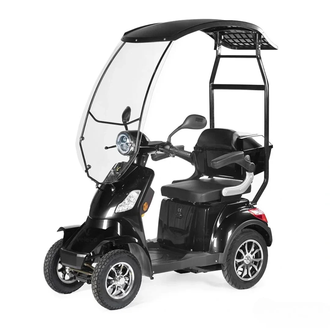 Electric Mobility Scooter Veleco Faster features a sleek black design, a protective canopy, comfortable seating, and three sturdy wheels.